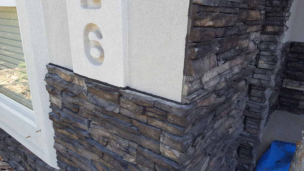 Stone pillars on on side of home. 